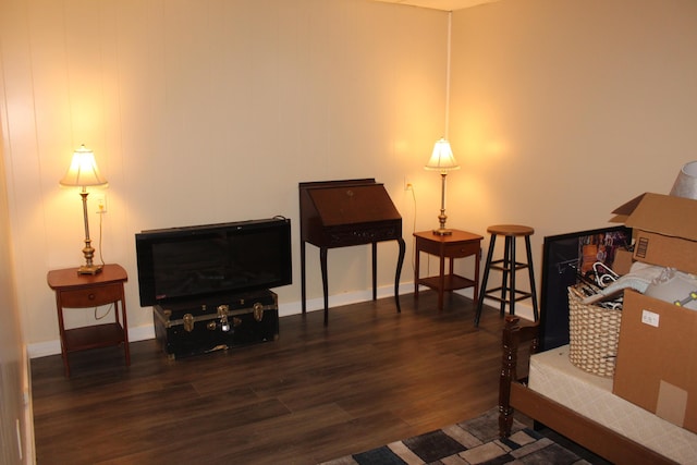 living area featuring wood finished floors and baseboards