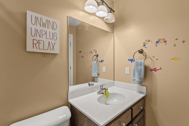 half bath featuring toilet and vanity