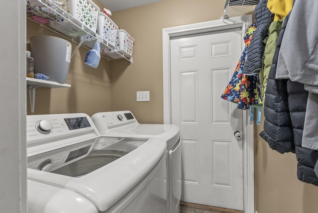 clothes washing area with washer and dryer