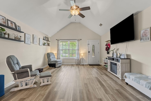 sitting room with a ceiling fan, wood finished floors, lofted ceiling, and baseboards