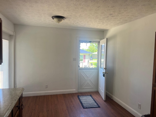 104 Arvin Dr, Lancaster, KY 40444 - doorway to outside with dark wood-style floors, baseboards, and a textured ceiling
