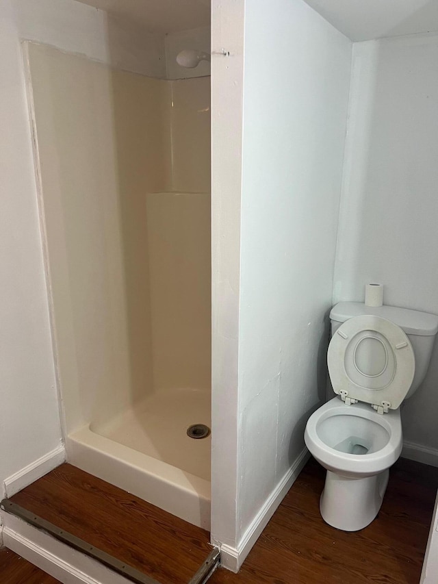 104 Arvin Dr, Lancaster, KY 40444 - full bath with baseboards, a stall shower, toilet, and wood finished floors