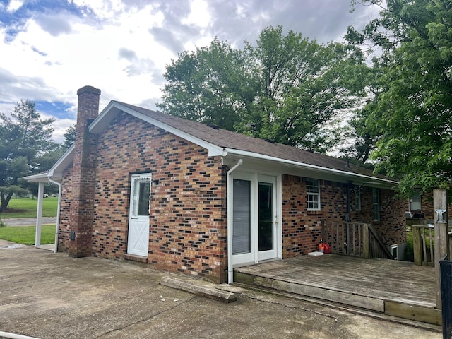 104 Arvin Dr, Lancaster, KY 40444 - rear view of house featuring a wooden deck, a chimney, and brick siding