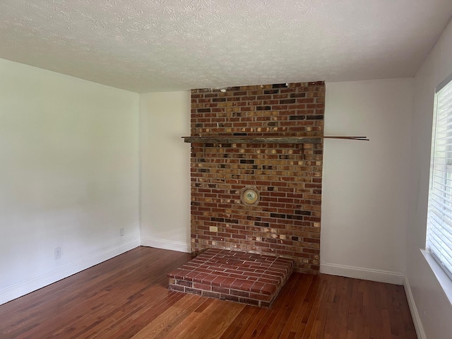 104 Arvin Dr, Lancaster, KY 40444 - unfurnished living room with hardwood / wood-style flooring, a textured ceiling, and baseboards