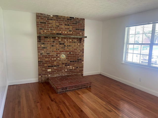 104 Arvin Dr, Lancaster, KY 40444 - unfurnished living room featuring wood finished floors, baseboards, and a textured ceiling