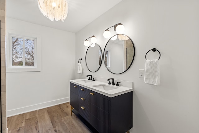 543 Laketower Dr Unit 140, Lexington, KY 40502 - bathroom with wood finished floors, baseboards, double vanity, and a chandelier