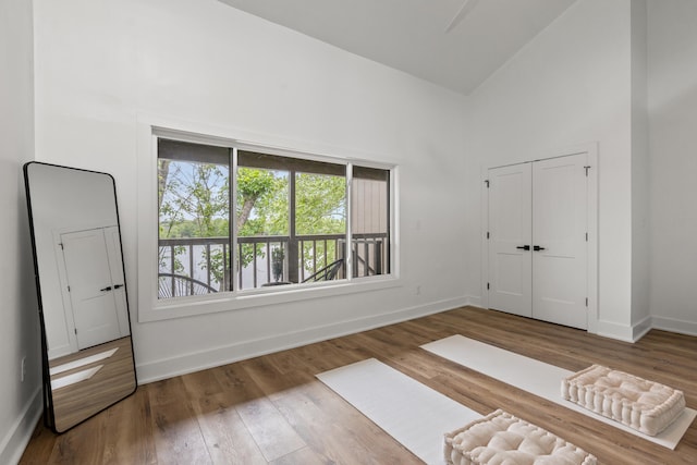 543 Laketower Dr Unit 140, Lexington, KY 40502 - unfurnished bedroom featuring high vaulted ceiling, baseboards, wood finished floors, and a closet