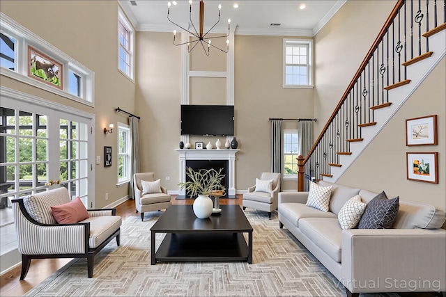 4301 Ravens Crest Ln, Lexington, KY 40515 - living room with a towering ceiling, healthy amount of natural light, a chandelier, wood finished floors, and ornamental molding