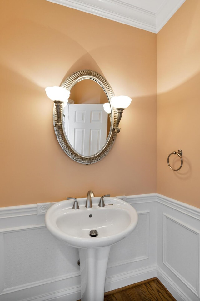 4301 Ravens Crest Ln, Lexington, KY 40515 - bathroom featuring wainscoting, a decorative wall, wood finished floors, and crown molding