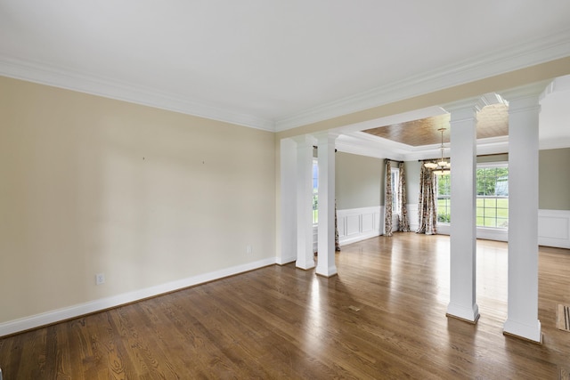 4301 Ravens Crest Ln, Lexington, KY 40515 - unfurnished living room with ornate columns, a chandelier, ornamental molding, wood finished floors, and a decorative wall