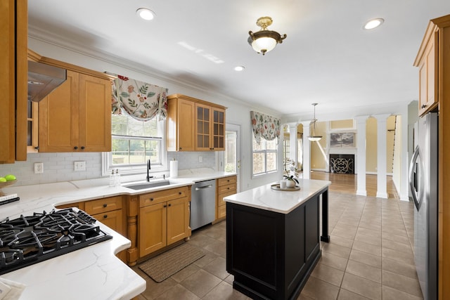 4301 Ravens Crest Ln, Lexington, KY 40515 - kitchen featuring stainless steel appliances, a sink, ornate columns, tasteful backsplash, and a kitchen island