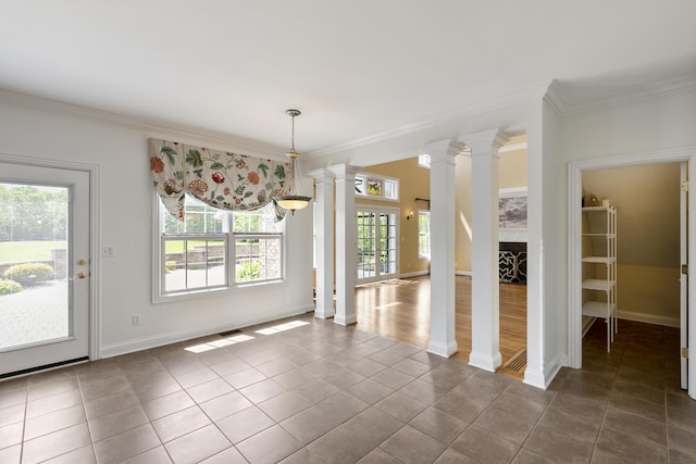 4301 Ravens Crest Ln, Lexington, KY 40515 - unfurnished dining area featuring ornate columns, crown molding, dark tile patterned flooring, and baseboards