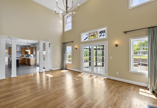 4301 Ravens Crest Ln, Lexington, KY 40515 - unfurnished living room with french doors, baseboards, healthy amount of natural light, a towering ceiling, and ornamental molding