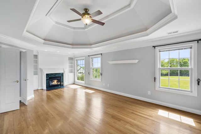 4301 Ravens Crest Ln, Lexington, KY 40515 - unfurnished living room with a raised ceiling, ceiling fan, a premium fireplace, light wood finished floors, and ornamental molding