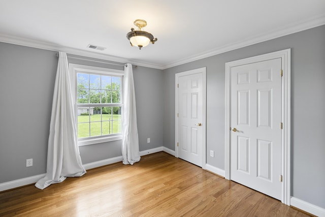 4301 Ravens Crest Ln, Lexington, KY 40515 - unfurnished bedroom with ornamental molding, light wood-type flooring, and baseboards
