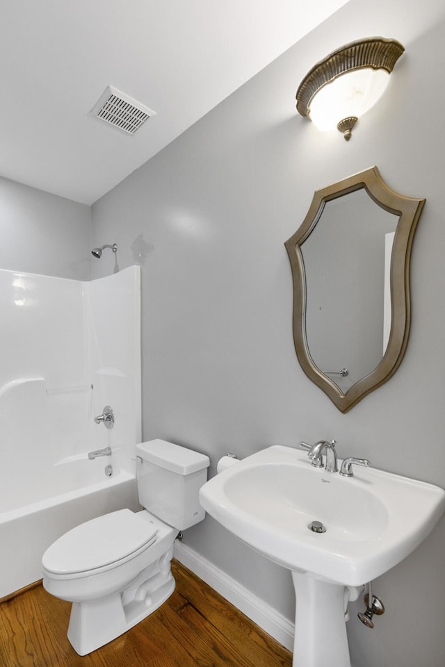 4301 Ravens Crest Ln, Lexington, KY 40515 - bathroom featuring wood finished floors, toilet, shower / bathtub combination, and a sink