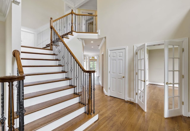 4301 Ravens Crest Ln, Lexington, KY 40515 - staircase featuring french doors, wood finished floors, a high ceiling, and crown molding