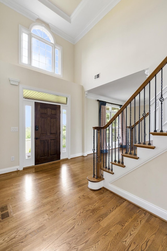 4301 Ravens Crest Ln, Lexington, KY 40515 - foyer featuring wood finished floors, a high ceiling, baseboards, crown molding, and stairs