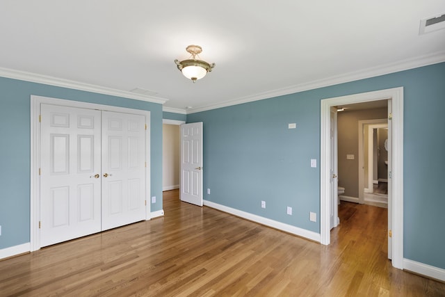 4301 Ravens Crest Ln, Lexington, KY 40515 - unfurnished bedroom with baseboards, light wood-style floors, crown molding, and a closet