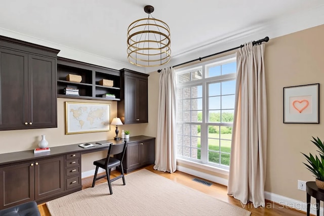 4301 Ravens Crest Ln, Lexington, KY 40515 - office area with built in desk, a chandelier, and light wood-style floors