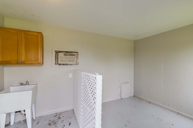 4301 Ravens Crest Ln, Lexington, KY 40515 - washroom featuring a wall mounted AC, cabinet space, and baseboards