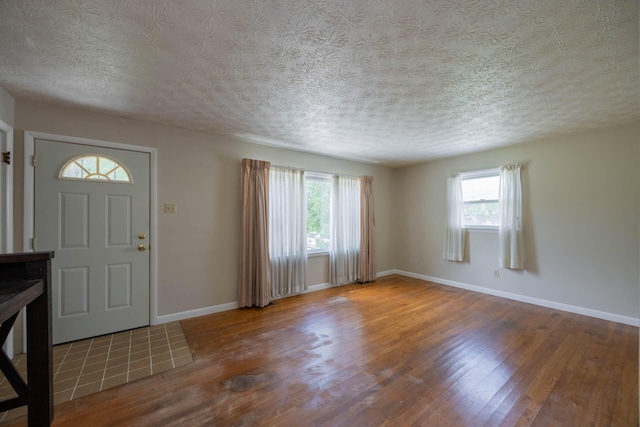 1667 Strader Dr, Lexington, KY 40505 - entryway with wood finished floors, a textured ceiling, and baseboards