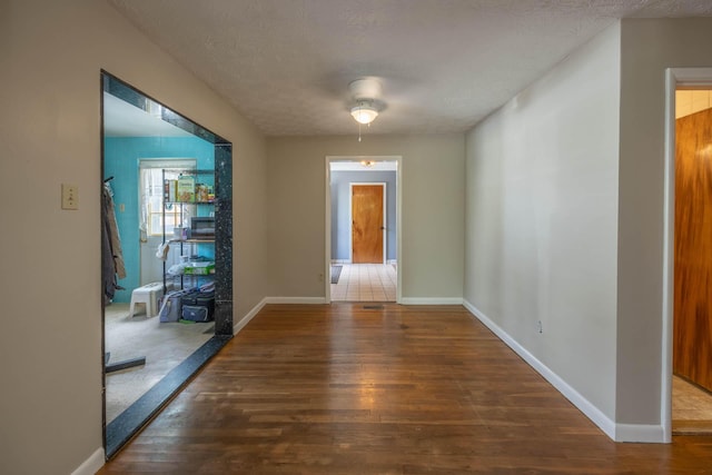 1667 Strader Dr, Lexington, KY 40505 - corridor with wood finished floors, baseboards, and a textured ceiling