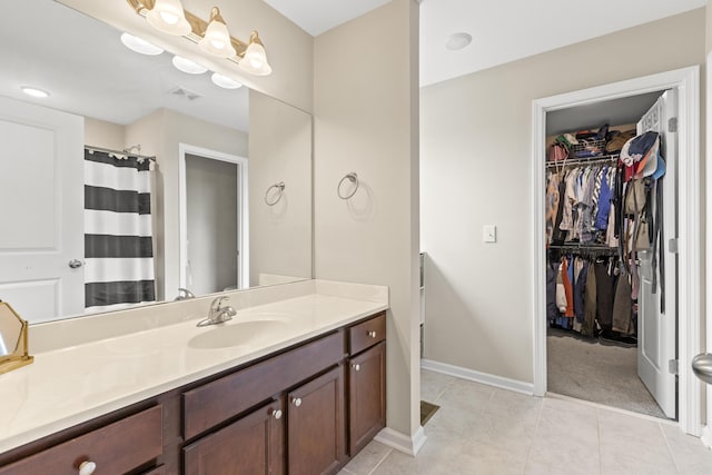 2768 Red Clover Ln, Lexington, KY 40511 - bathroom with vanity, a spacious closet, tile patterned flooring, and baseboards
