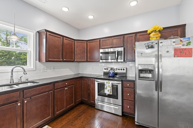 2768 Red Clover Ln, Lexington, KY 40511 - kitchen with stainless steel appliances, a sink, dark wood finished floors, decorative backsplash, and hanging light fixtures