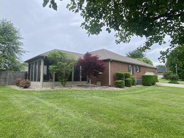 319 Huckleberry Ln, London, KY 40744 - view of side of home featuring central AC, a sunroom, a garage, and brick siding