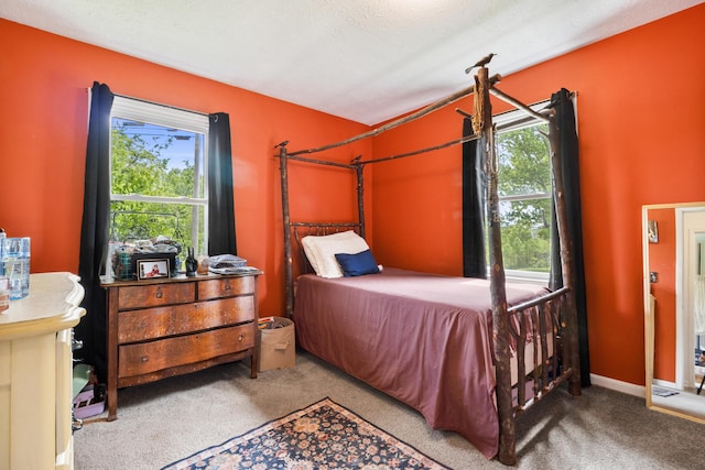 carpeted bedroom featuring multiple windows