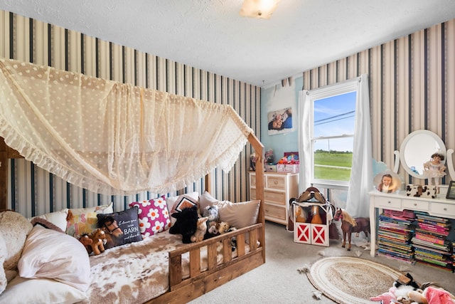 playroom with wallpapered walls, carpet, and a textured ceiling