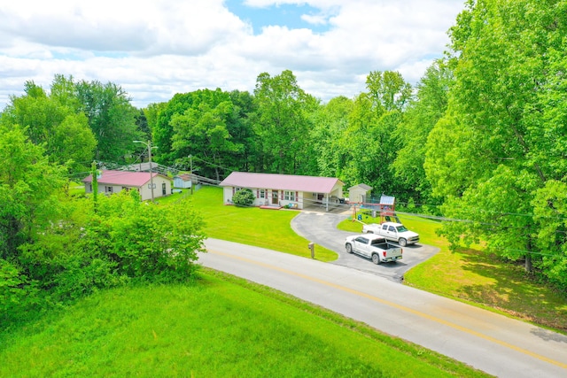 view of subject property with a forest
