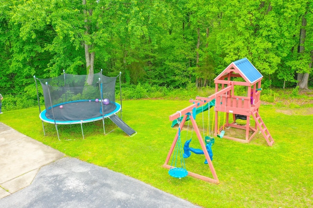 view of jungle gym with a trampoline and a lawn