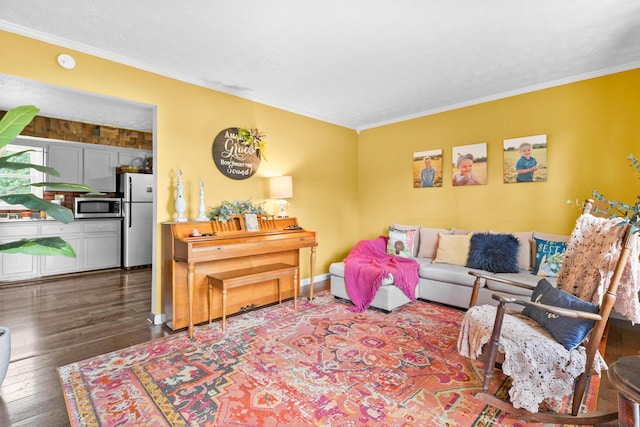living area with crown molding and wood-type flooring