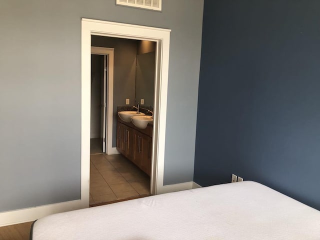 535 S Upper St Unit 317, Lexington, KY 40508 - bedroom featuring tile patterned floors and a sink