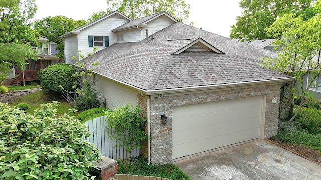 1667 Snow Goose Cir, Lexington, KY 40511 - view of front of property featuring roof with shingles, an attached garage, stone siding, and concrete driveway