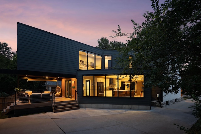 252 Cochran Rd, Lexington, KY 40502 - back of property at dusk with a deck and a patio