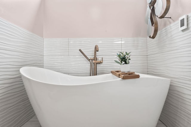 252 Cochran Rd, Lexington, KY 40502 - bathroom featuring tile walls, a sink, a freestanding tub, and a wainscoted wall