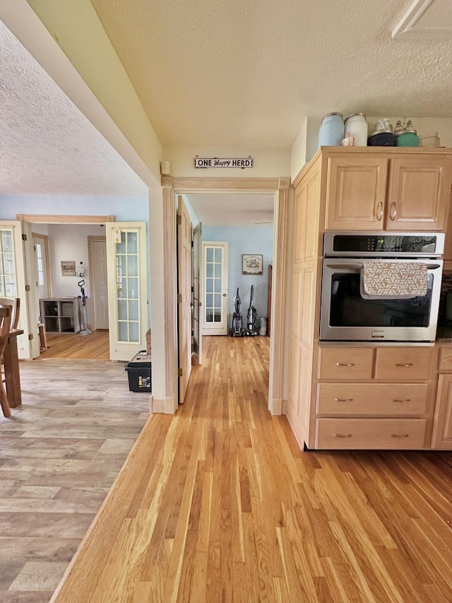 3125 Old Bull Rd, Eubank, KY 42567 - kitchen featuring oven, light brown cabinets, a textured ceiling, french doors, and light wood-type flooring