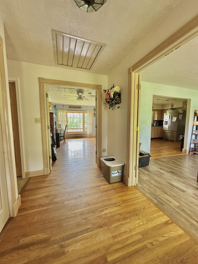 3125 Old Bull Rd, Eubank, KY 42567 - corridor with a textured ceiling and light wood-type flooring