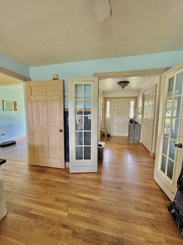 3125 Old Bull Rd, Eubank, KY 42567 - foyer entrance with wood finished floors, a textured ceiling, plenty of natural light, and french doors