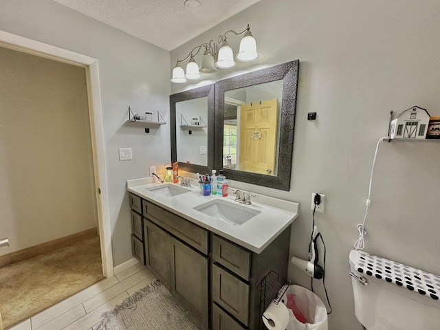 3125 Old Bull Rd, Eubank, KY 42567 - full bathroom featuring double vanity, toilet, a textured ceiling, and baseboards