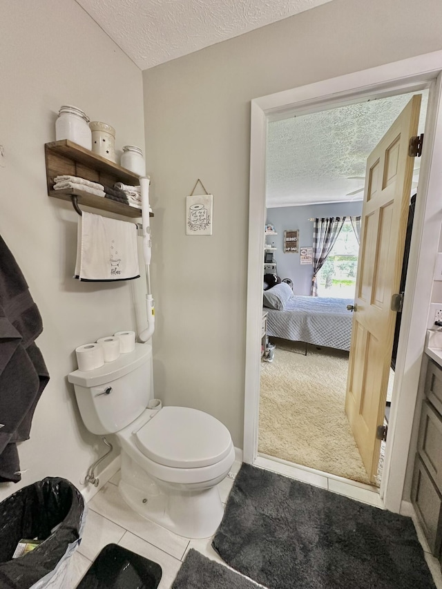 3125 Old Bull Rd, Eubank, KY 42567 - ensuite bathroom with a textured ceiling, toilet, tile patterned flooring, vanity, and baseboards