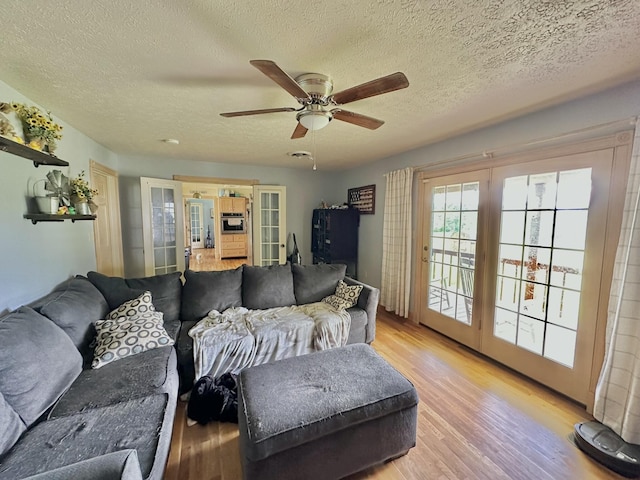 3125 Old Bull Rd, Eubank, KY 42567 - living room with a textured ceiling, light wood-style floors, ceiling fan, and french doors