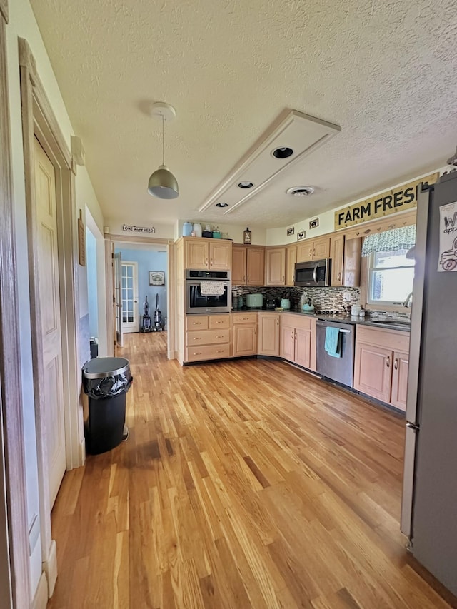 3125 Old Bull Rd, Eubank, KY 42567 - kitchen with stainless steel appliances, light brown cabinetry, light wood-type flooring, a sink, and dark countertops