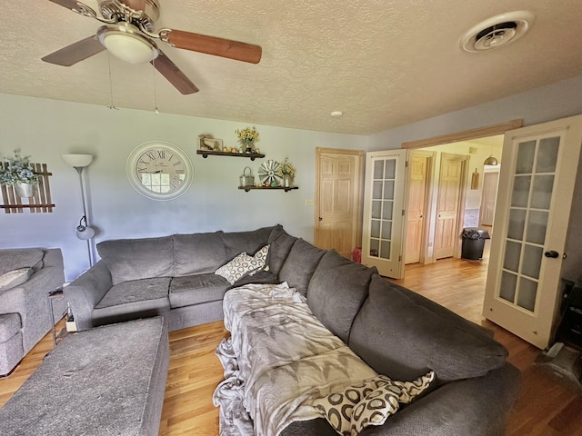 3125 Old Bull Rd, Eubank, KY 42567 - living area featuring french doors, wood finished floors, a textured ceiling, and ceiling fan