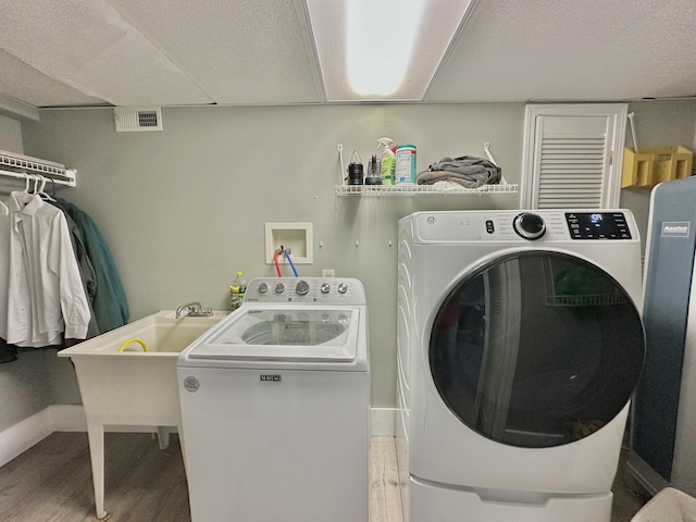 3125 Old Bull Rd, Eubank, KY 42567 - washroom featuring separate washer and dryer, wood finished floors, and baseboards
