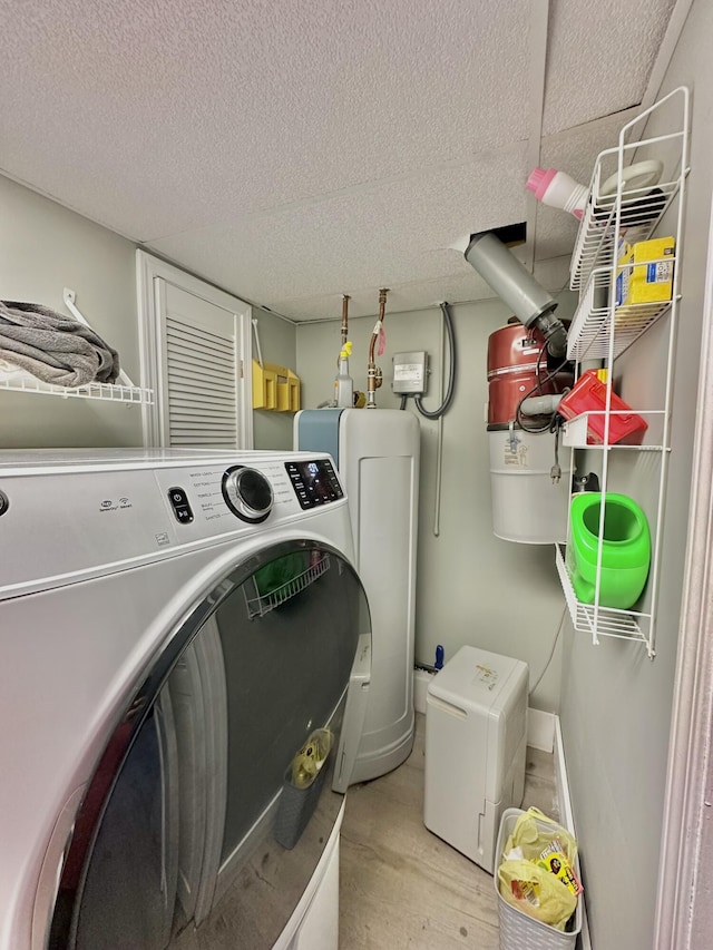 3125 Old Bull Rd, Eubank, KY 42567 - laundry room with washer / clothes dryer, light wood finished floors, a textured ceiling, and water heater