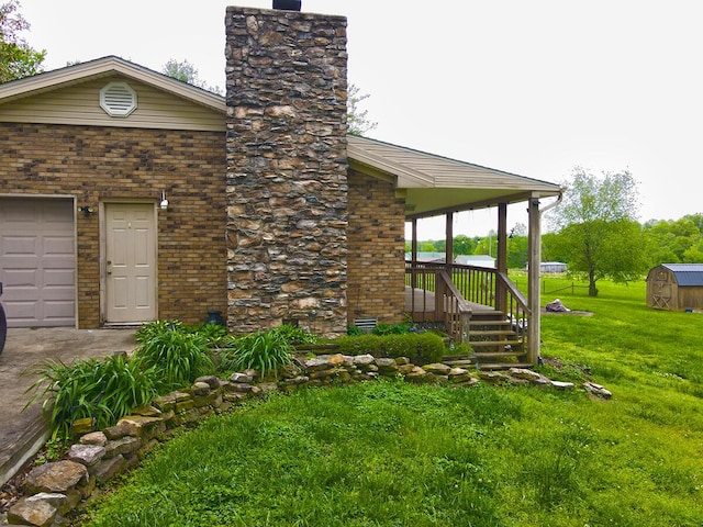 3125 Old Bull Rd, Eubank, KY 42567 - view of property exterior with a chimney, a yard, brick siding, and a garage